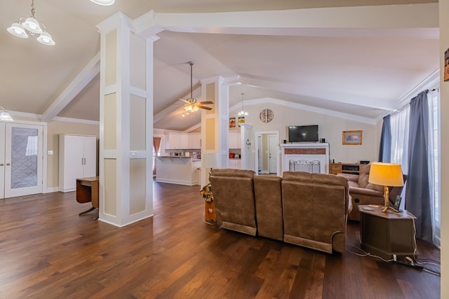 living room featuring ceiling fan, dark hardwood / wood-style flooring, lofted ceiling with beams, and decorative columns