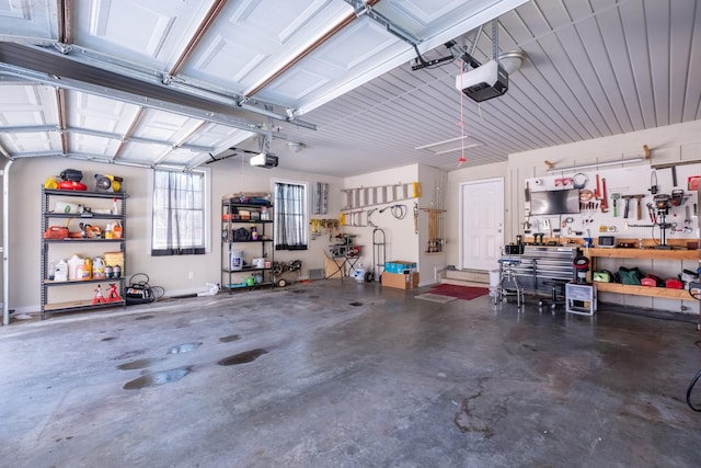 garage featuring a garage door opener and a workshop area