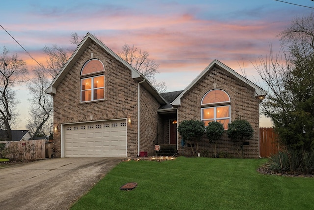 view of property featuring a garage and a lawn