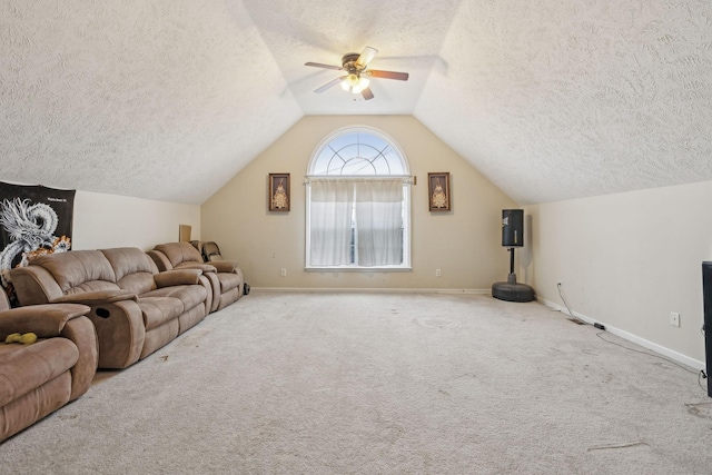 living room with vaulted ceiling, light carpet, ceiling fan, and a textured ceiling