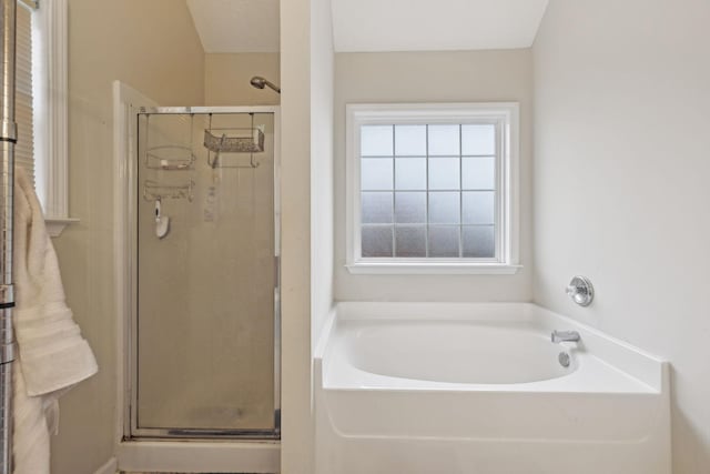 bathroom featuring shower with separate bathtub