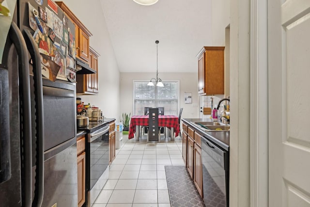 kitchen with appliances with stainless steel finishes, sink, a chandelier, hanging light fixtures, and light tile patterned floors