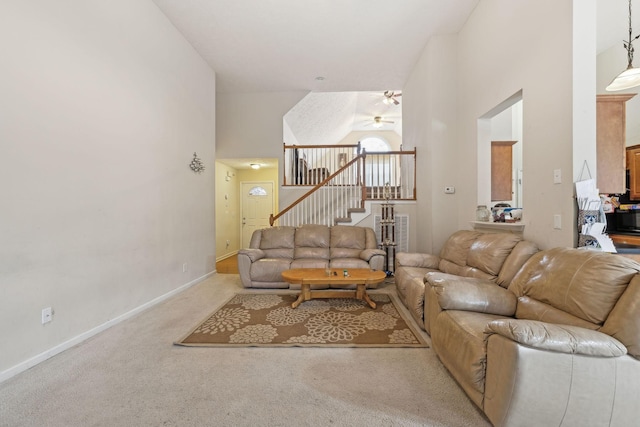 carpeted living room with high vaulted ceiling and ceiling fan