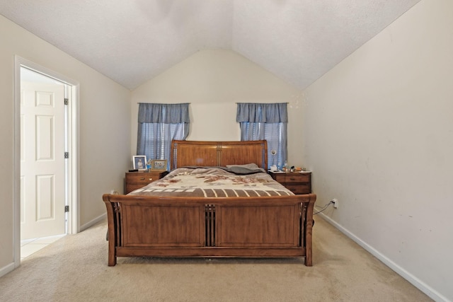 carpeted bedroom with lofted ceiling