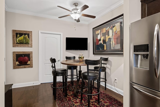 dining room with ornamental molding, dark wood-type flooring, and ceiling fan