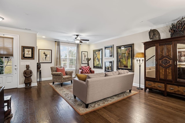 living room with dark wood-type flooring, ceiling fan, and crown molding