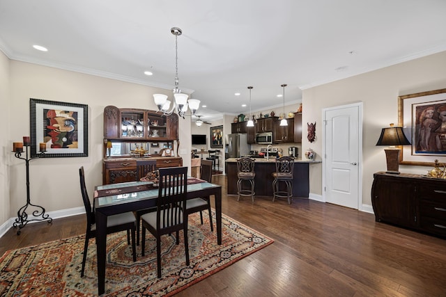 dining space with an inviting chandelier, ornamental molding, and dark hardwood / wood-style flooring