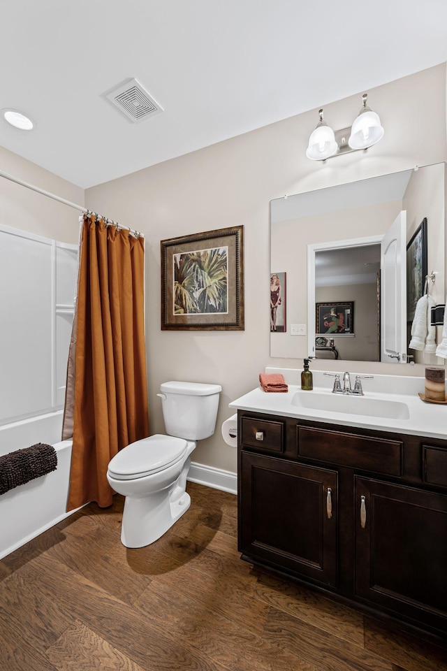 full bathroom featuring vanity, wood-type flooring, shower / tub combo, and toilet