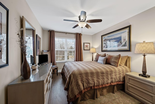 bedroom with dark hardwood / wood-style floors and ceiling fan