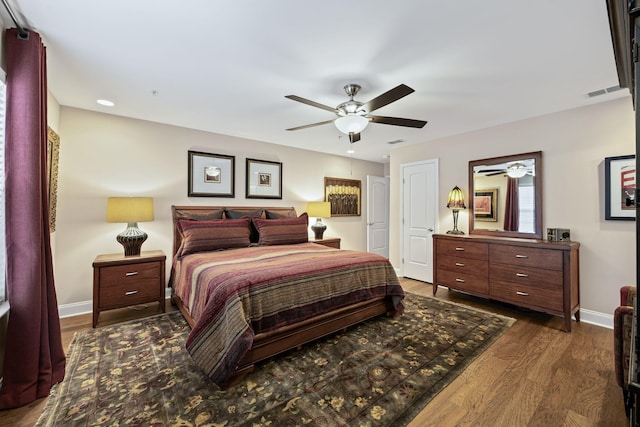 bedroom with dark wood-type flooring and ceiling fan