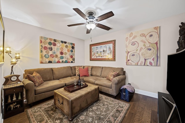 living room featuring dark wood-type flooring and ceiling fan