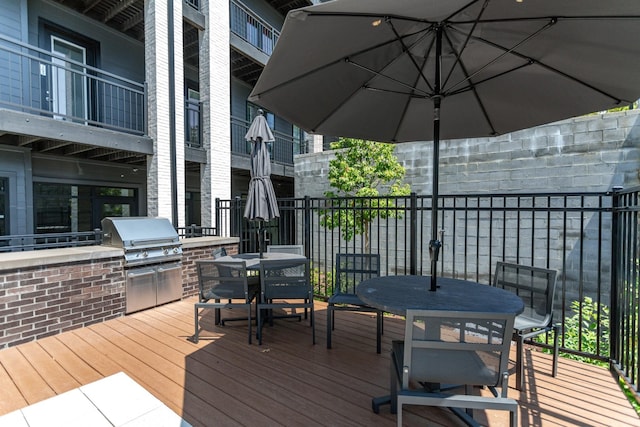 deck with an outdoor kitchen and area for grilling