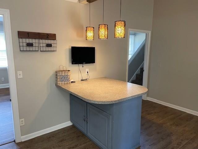 kitchen with dark hardwood / wood-style floors, pendant lighting, and kitchen peninsula