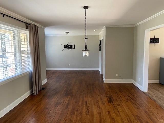 unfurnished dining area featuring dark wood-type flooring and ornamental molding