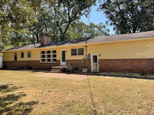 rear view of property with a yard