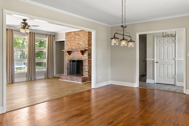 unfurnished living room with ceiling fan, ornamental molding, hardwood / wood-style floors, and a brick fireplace