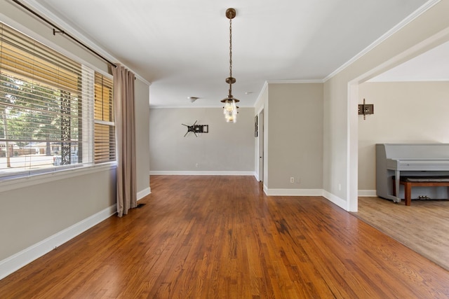 spare room with hardwood / wood-style flooring and crown molding