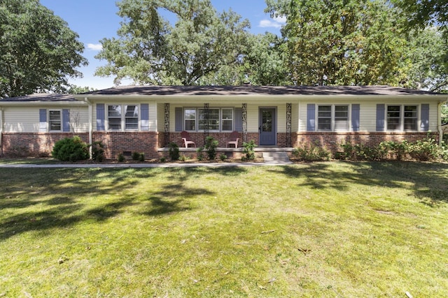 ranch-style house featuring a porch and a front lawn