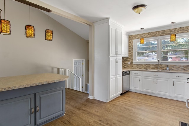 kitchen with decorative light fixtures, white cabinetry, dishwasher, sink, and light hardwood / wood-style flooring