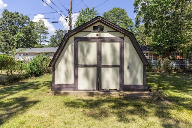 view of outdoor structure featuring a lawn