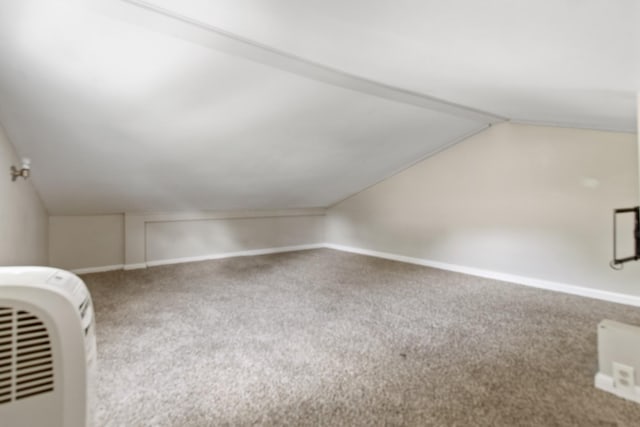 bonus room featuring lofted ceiling and carpet flooring