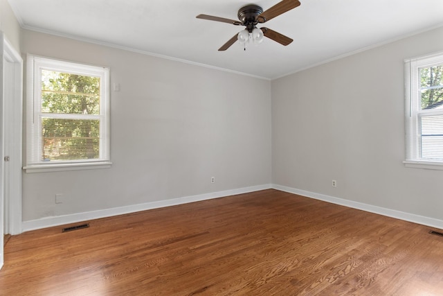 unfurnished room featuring hardwood / wood-style flooring, ceiling fan, and crown molding