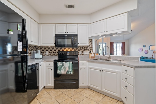 kitchen with white cabinetry, sink, backsplash, and black appliances