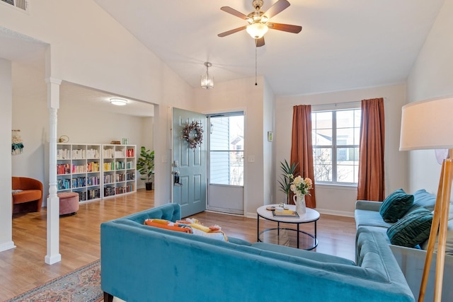 living room featuring lofted ceiling, hardwood / wood-style floors, and ceiling fan