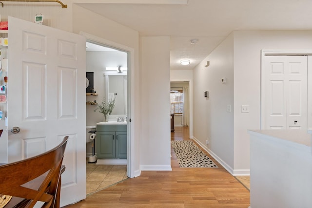 hallway with light hardwood / wood-style floors