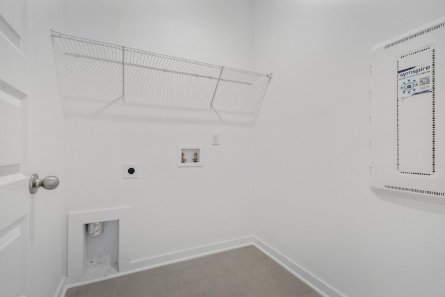 laundry room with electric dryer hookup, hookup for a washing machine, and tile patterned floors