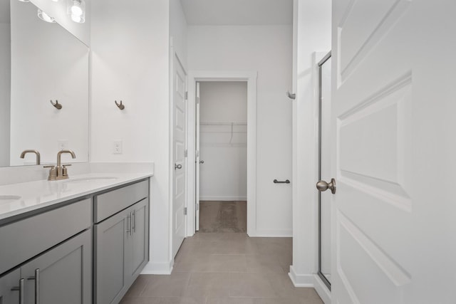 bathroom featuring vanity, tile patterned flooring, and walk in shower