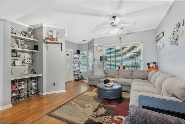 living room featuring crown molding, hardwood / wood-style floors, and ceiling fan