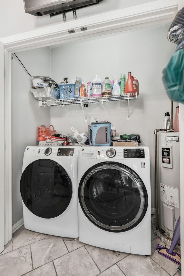 clothes washing area featuring washer and dryer and water heater