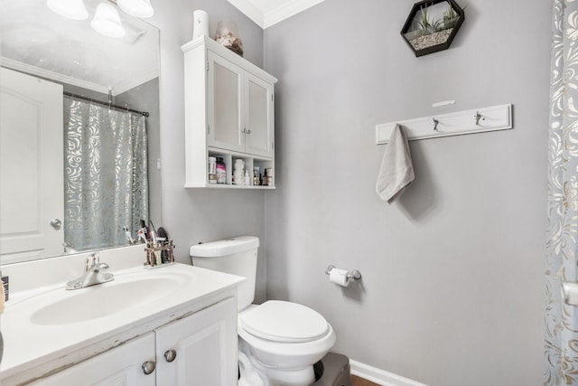 bathroom with crown molding, vanity, and toilet