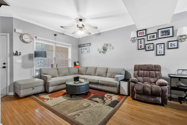 living room with hardwood / wood-style flooring, crown molding, and ceiling fan