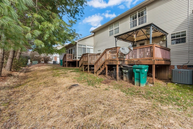 back of property with cooling unit and a deck