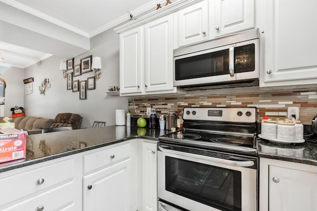 kitchen with white cabinetry, ornamental molding, and stainless steel appliances