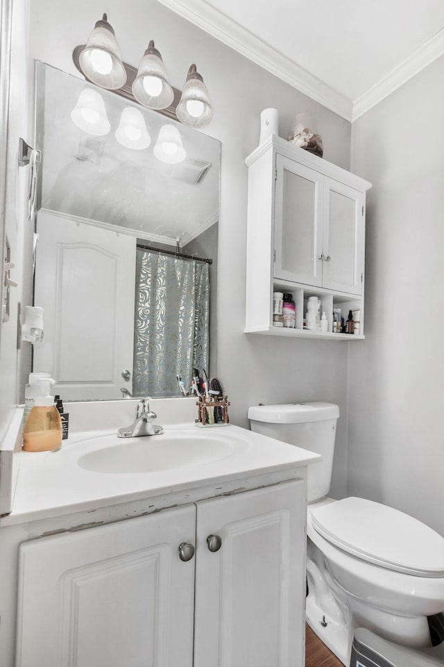 bathroom with ornamental molding, curtained shower, vanity, and toilet