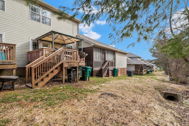 back of property featuring a gazebo and a deck