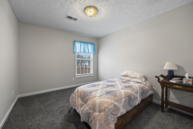 carpeted bedroom featuring a textured ceiling