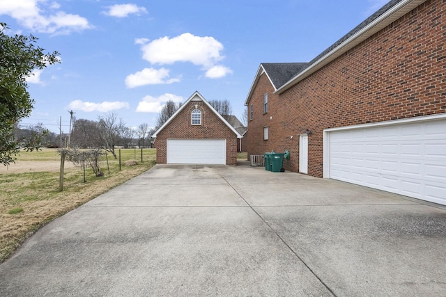 view of side of property featuring a garage and an outdoor structure