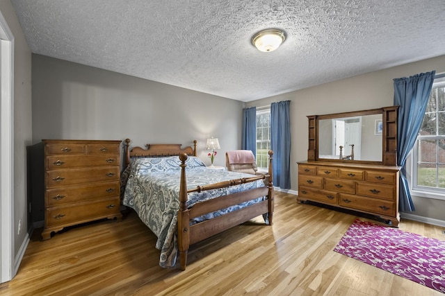 bedroom featuring hardwood / wood-style floors and a textured ceiling