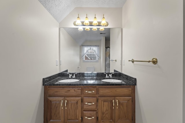 bathroom featuring vanity, lofted ceiling, and a textured ceiling