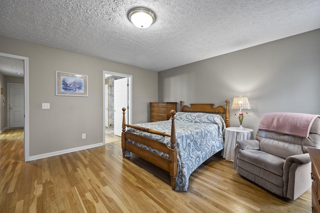 bedroom with wood-type flooring and a textured ceiling