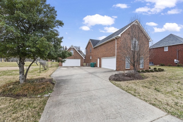 view of side of home with a garage and a lawn