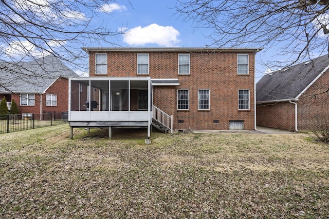 back of property with a lawn and a sunroom