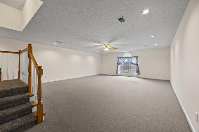 interior space with a textured ceiling and ceiling fan