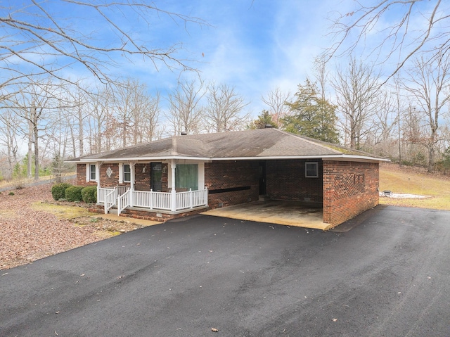 view of front of home with a carport and covered porch