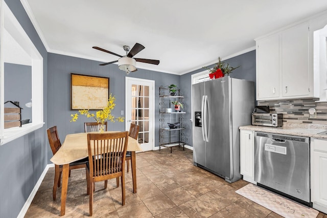 kitchen featuring stainless steel appliances, white cabinetry, ornamental molding, and backsplash