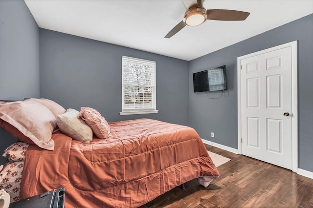 bedroom with dark hardwood / wood-style floors and ceiling fan